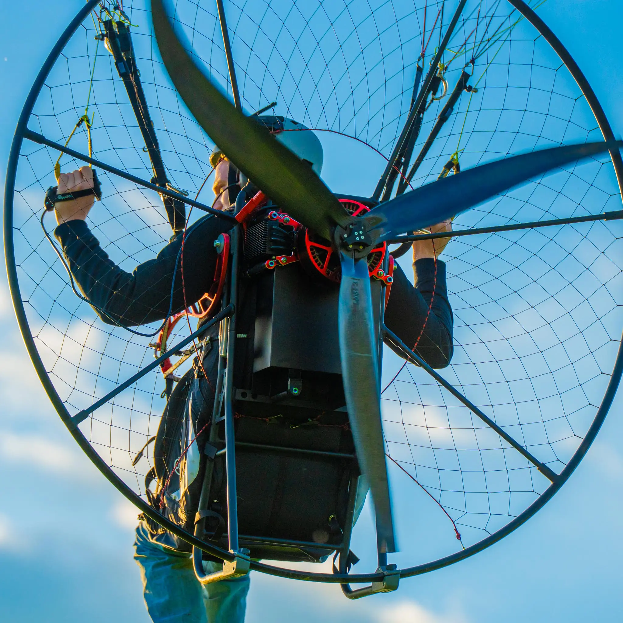 Paramotor launching from a grassy field